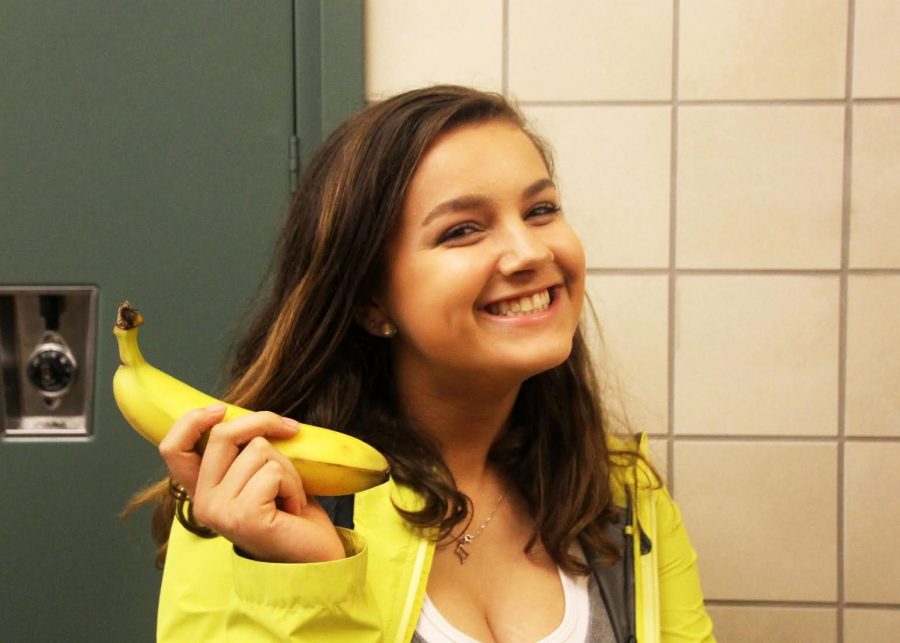 Abbey Korman holds a banana, which is vegan