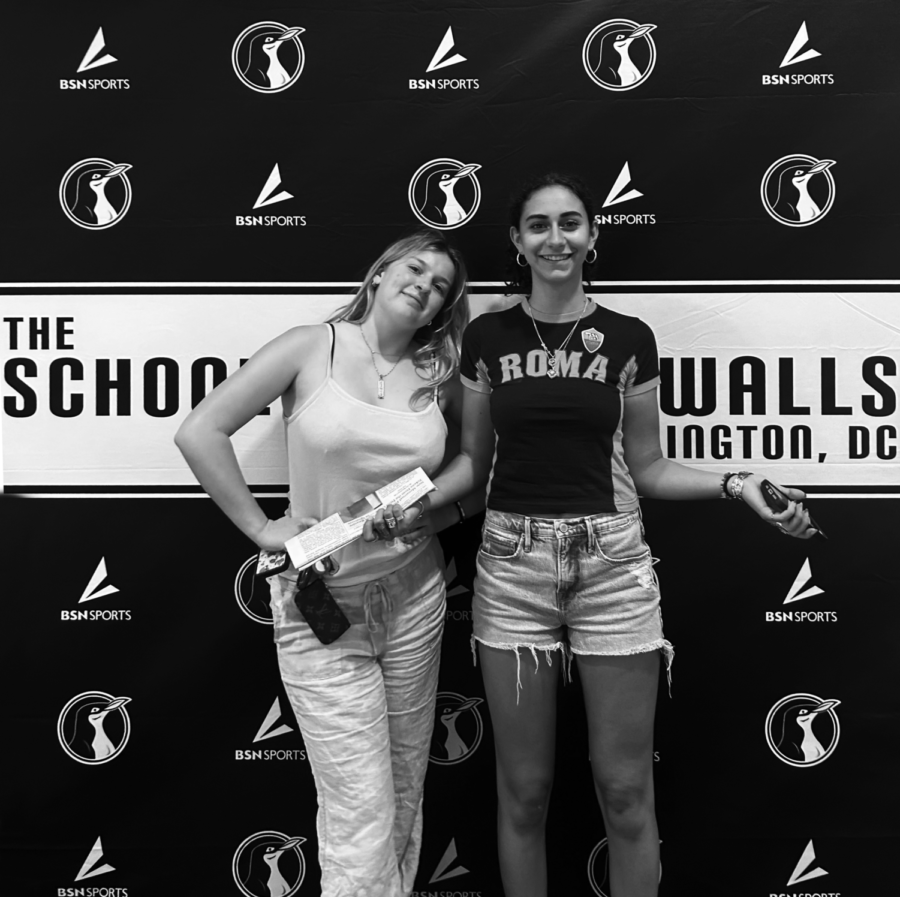 TIGERS IN BLACK AND WHITE - Esteemed rival review authors Rebecca Green and Francesca Purificato pose in front of SWW paraphernalia. The pair were underwhelmed by what the school had to offer.