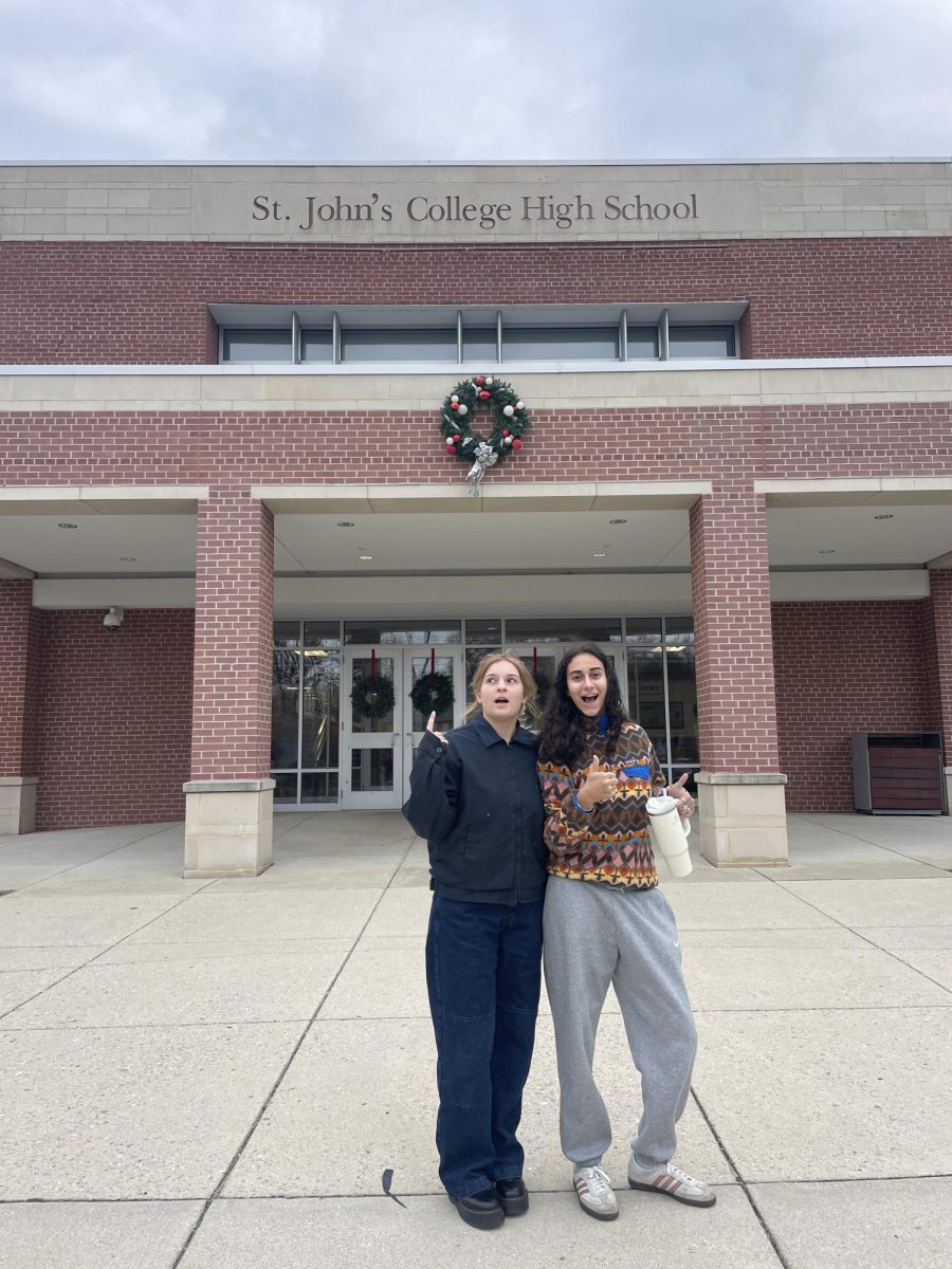 WHY AREN’T YOU IN UNIFORM? - Revered Rival Reviewers Francesca Purificado and Rebecca Green pose outside St. John’s College High School.