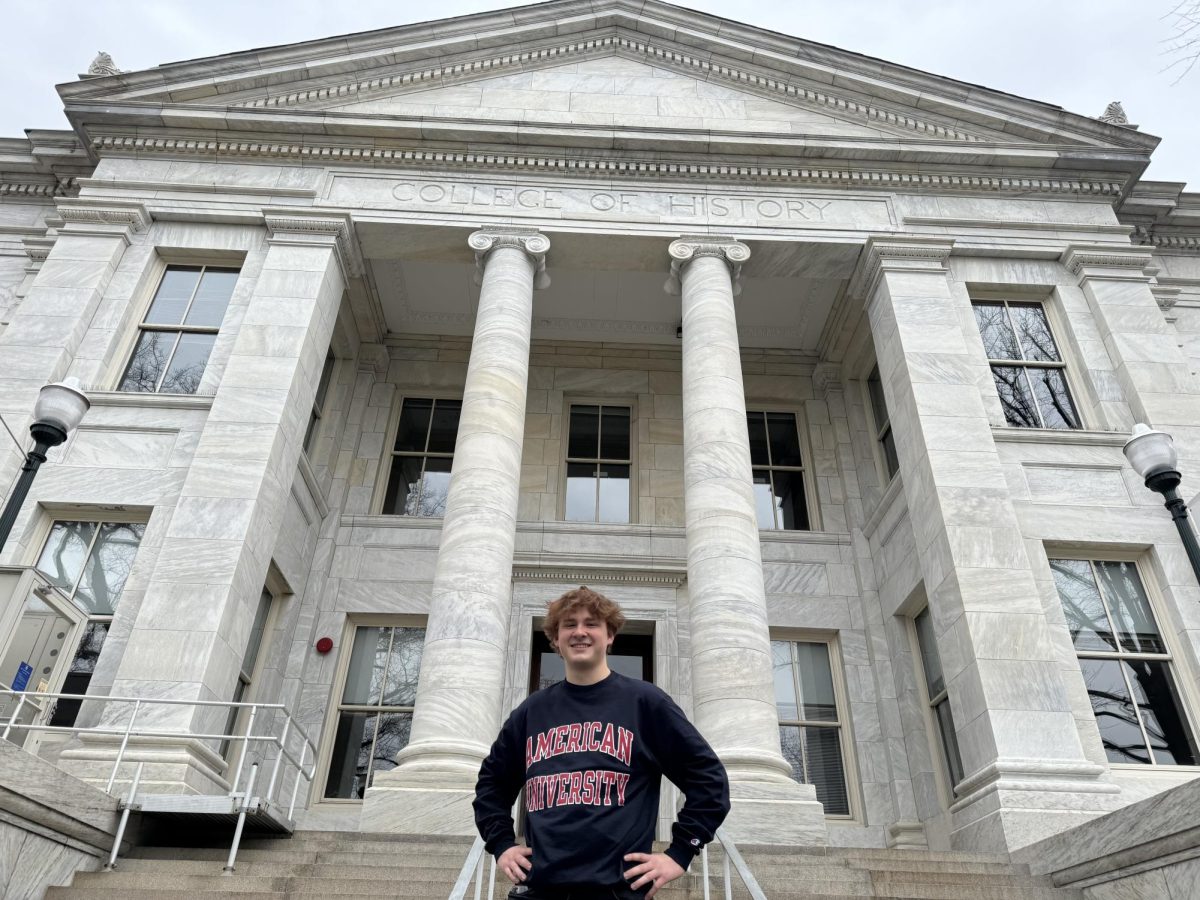 ACADEMIC WEAPON WES - Wesley Hoy flaunts his AU sweatshirt in front of the College of History. He rates his AU class, Statistical Programming in R, a 4/10.