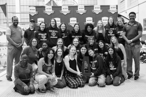 SMILING SWIMMERS - The Lady Tiger Sharks pose for a pic after winning the DCIAA championships. Claire Yoder was one of the members of the successful squad.