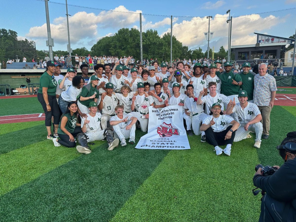 GOLDEN MOMENT - The Varsity Baseball boys pose for a picture with their newly won DCSAA Championship banner. The team beat the Maret Frogs late Sunday afternoon.
